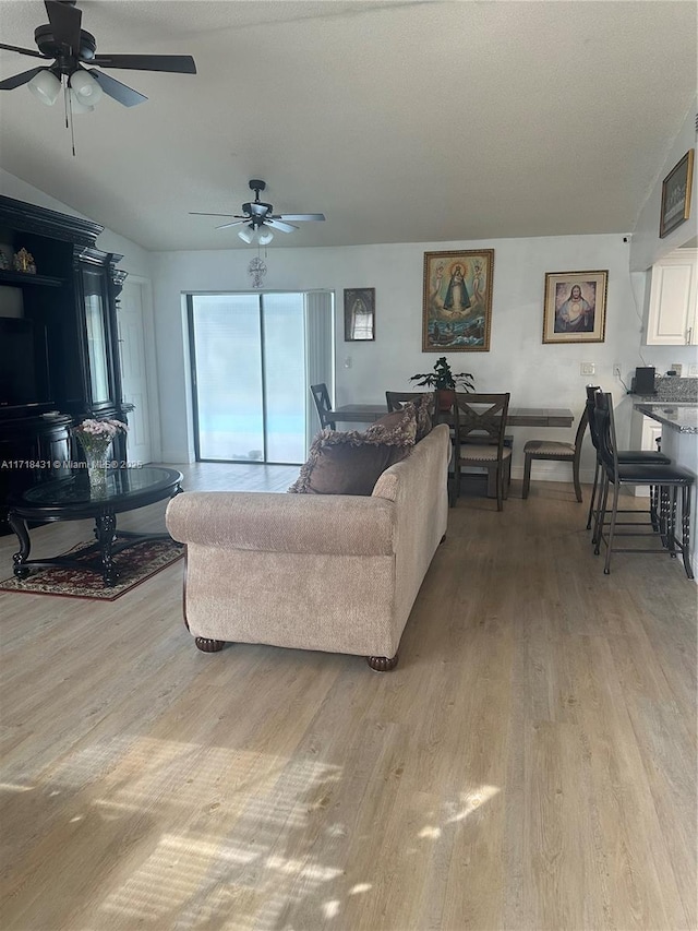 living room with light hardwood / wood-style flooring and ceiling fan