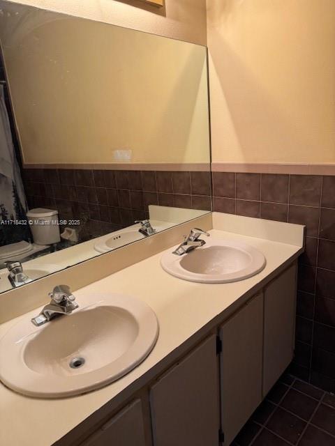 bathroom with tile patterned flooring and vanity