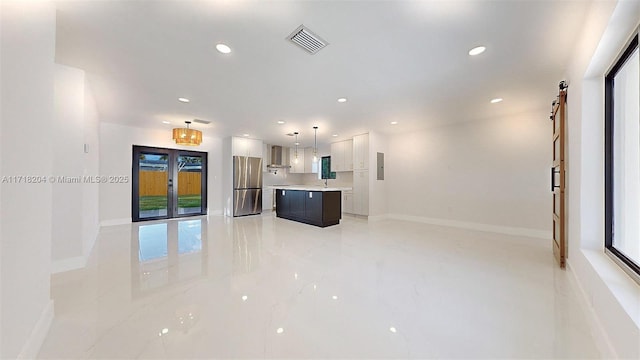 unfurnished living room featuring sink, electric panel, and french doors