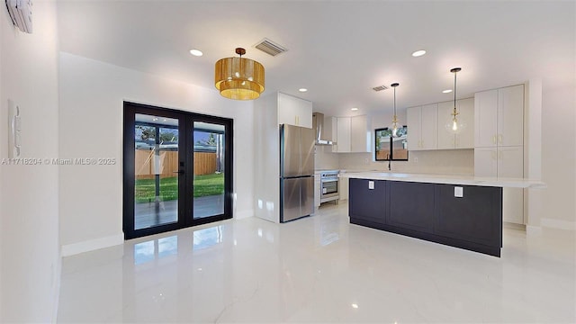 kitchen featuring white cabinetry, hanging light fixtures, stainless steel appliances, a center island, and french doors