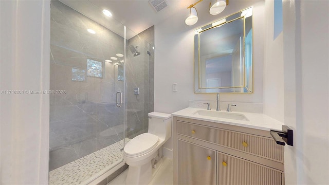 bathroom featuring vanity, an enclosed shower, and toilet