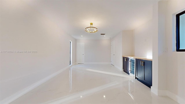 corridor with an inviting chandelier