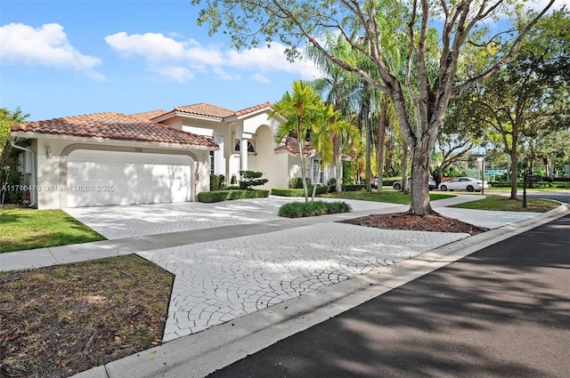 mediterranean / spanish home featuring a garage