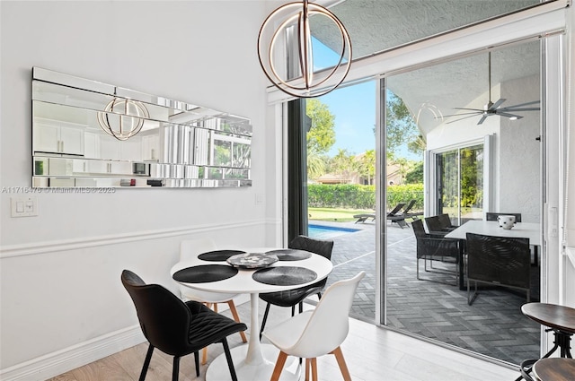 dining space featuring ceiling fan and wood-type flooring