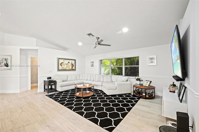 living room with ceiling fan, wood-type flooring, and vaulted ceiling