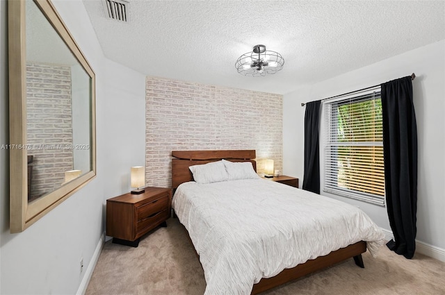 carpeted bedroom featuring a textured ceiling