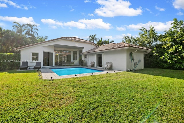 rear view of property featuring a patio area and a yard