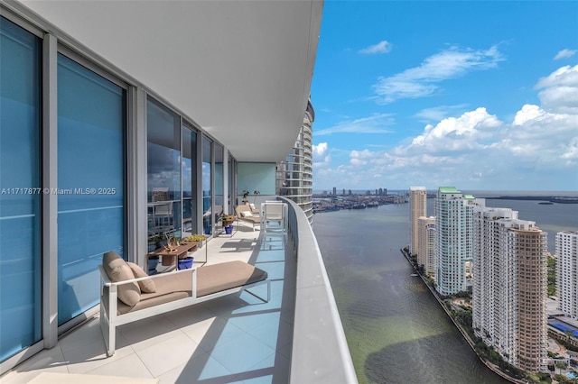 balcony featuring a city view and a water view