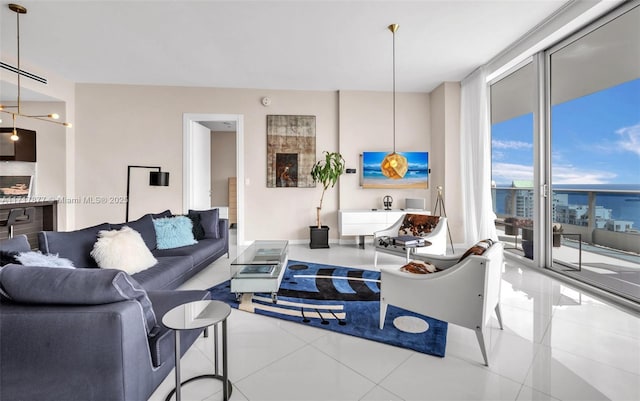 living area featuring tile patterned floors and a wall of windows