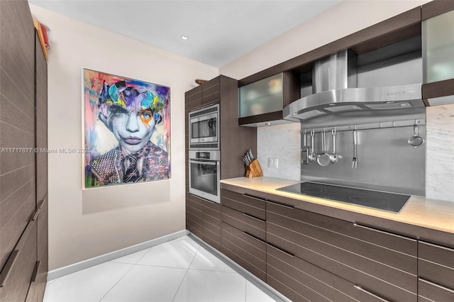 kitchen with light tile patterned floors, stainless steel appliances, light countertops, and baseboards