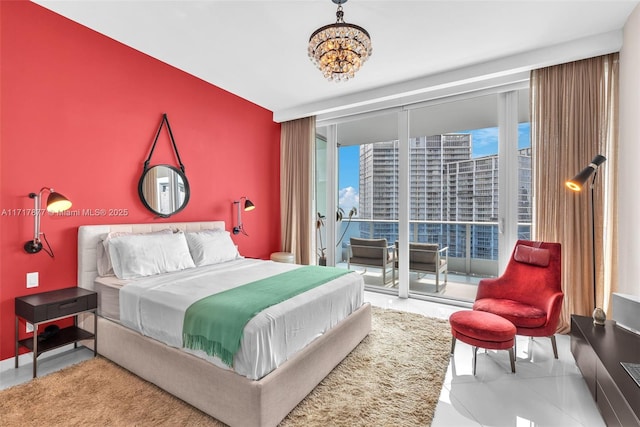 bedroom with a city view, access to outside, floor to ceiling windows, an inviting chandelier, and an accent wall