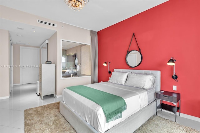 tiled bedroom featuring an accent wall, baseboards, and visible vents