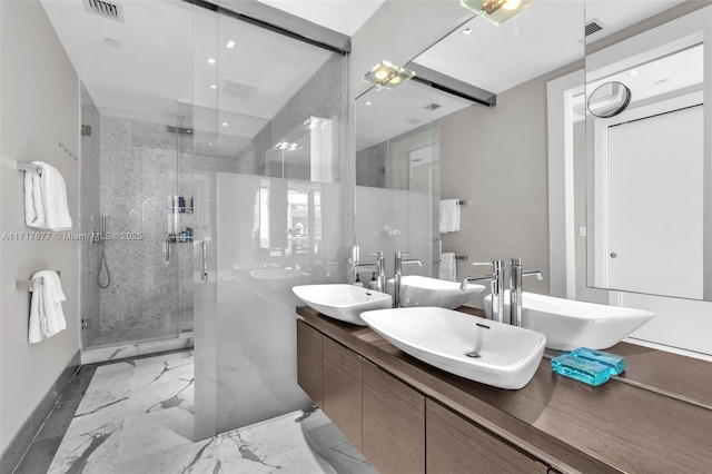 bathroom with a shower stall, visible vents, marble finish floor, and a sink