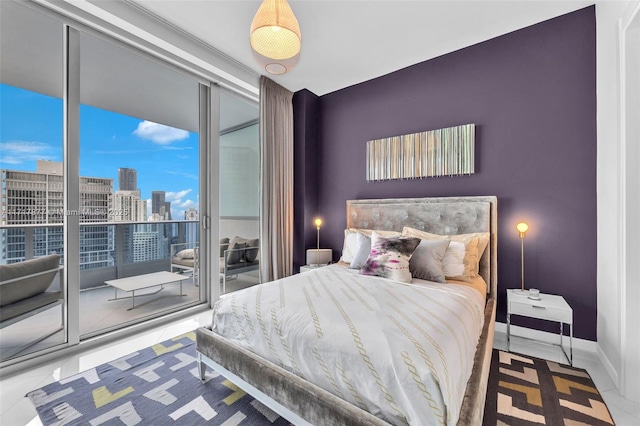 tiled bedroom with baseboards, a city view, and access to outside