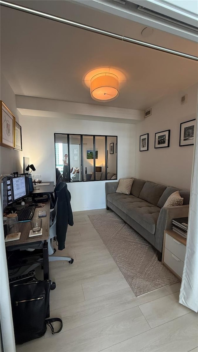 office with light wood-type flooring