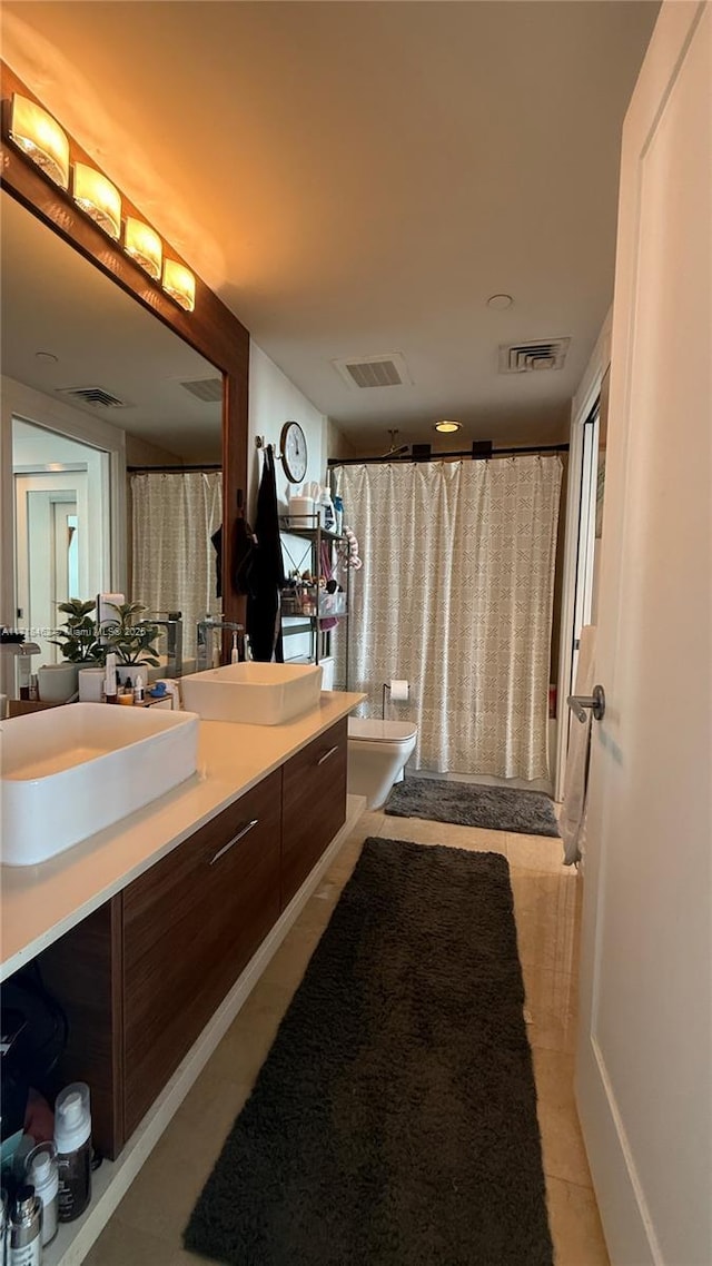 bathroom with vanity, walk in shower, tile patterned floors, and toilet