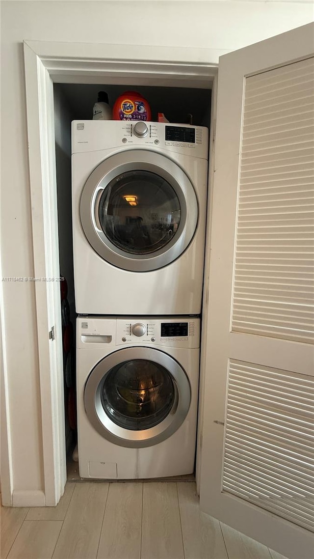 laundry room with stacked washing maching and dryer