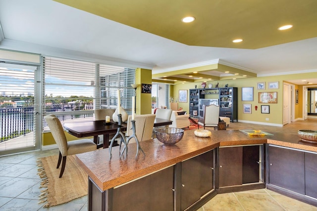 kitchen with dark brown cabinets, beamed ceiling, and ornamental molding