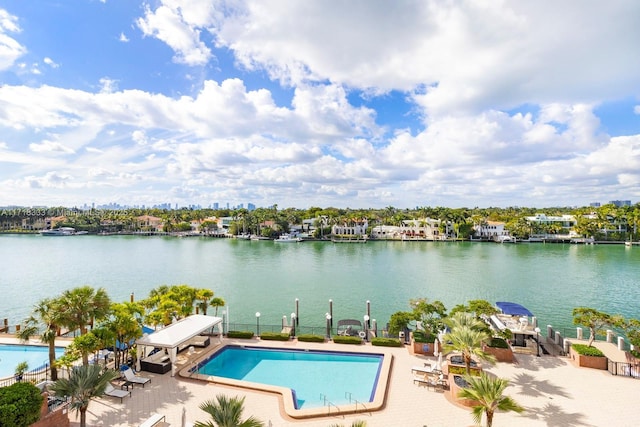 view of pool featuring a patio and a water view