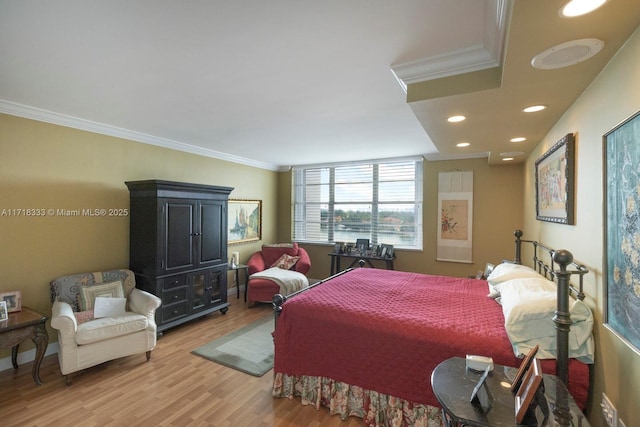 bedroom featuring hardwood / wood-style floors and crown molding