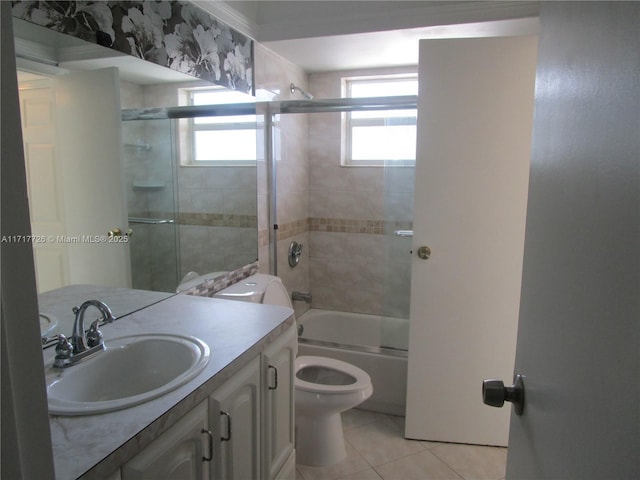 full bathroom with tile patterned flooring, vanity, bath / shower combo with glass door, and toilet