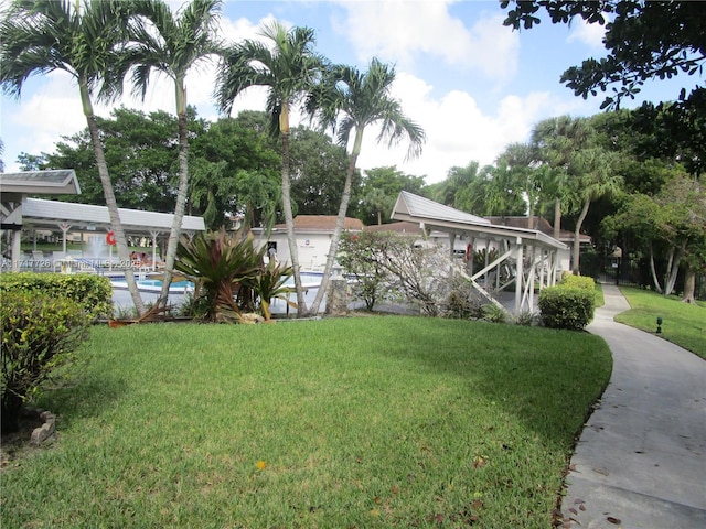 exterior space with a pool and a yard