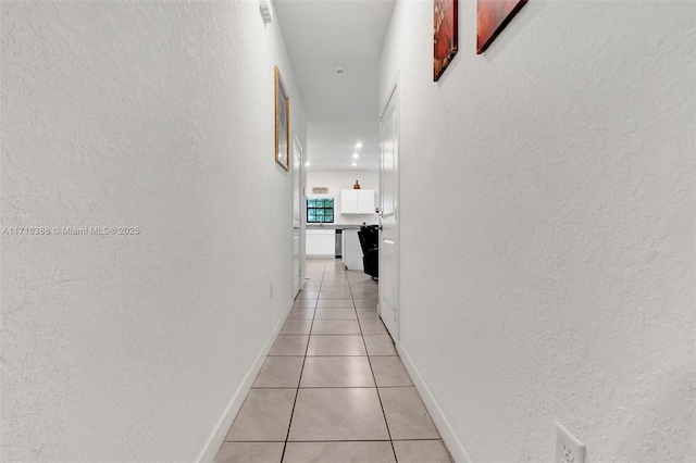 hallway with light tile patterned floors