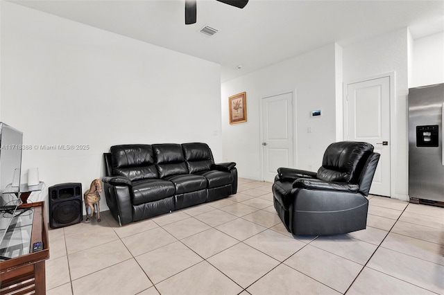 living room featuring ceiling fan and light tile patterned floors