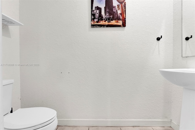 bathroom with tile patterned floors and toilet