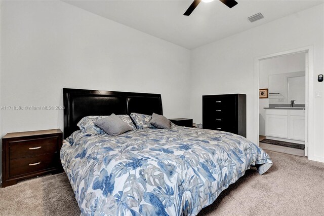 bedroom featuring light carpet, connected bathroom, ceiling fan, and sink