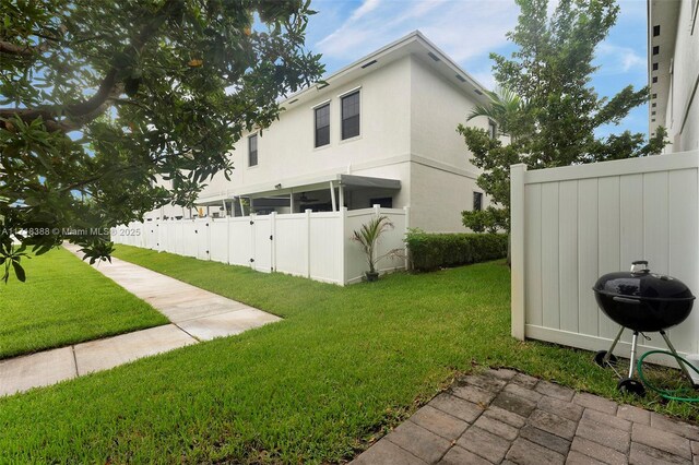 view of side of property with a lawn