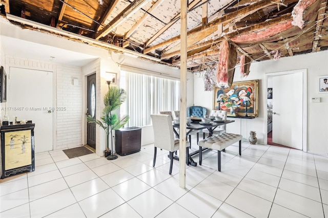 tiled dining room with brick wall