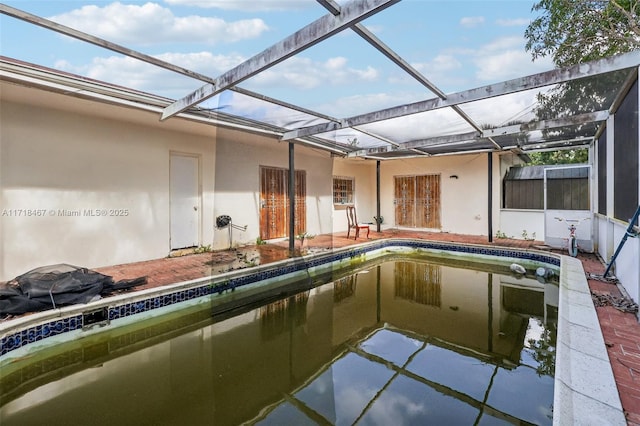 view of swimming pool featuring a lanai