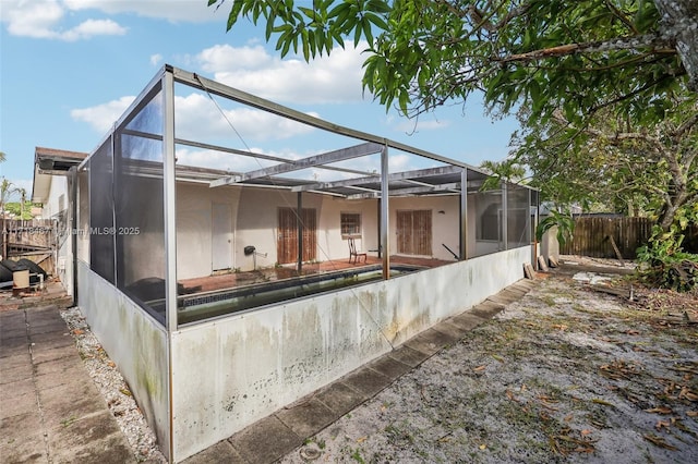 rear view of house featuring a lanai