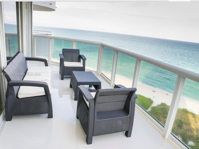 balcony with a beach view and a water view