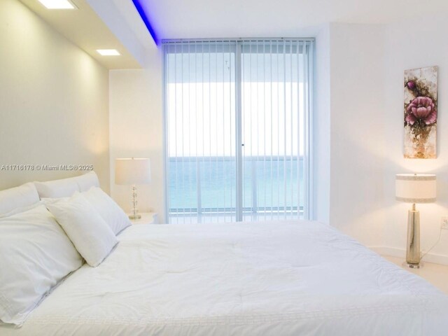 bedroom featuring a water view