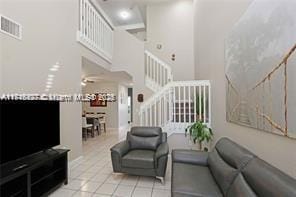 tiled living room with ceiling fan