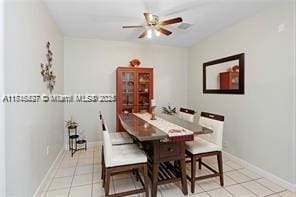 tiled dining space with ceiling fan