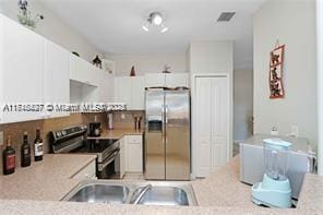 kitchen with white cabinets, sink, and stainless steel appliances