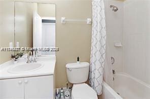 full bathroom featuring vanity, toilet, and shower / tub combo