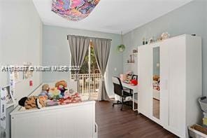 bedroom with dark wood-type flooring