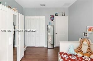 bedroom with dark wood-type flooring