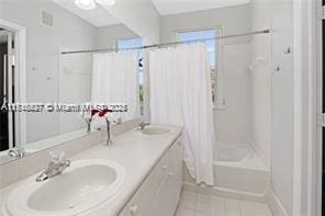 bathroom with vanity and shower / tub combo