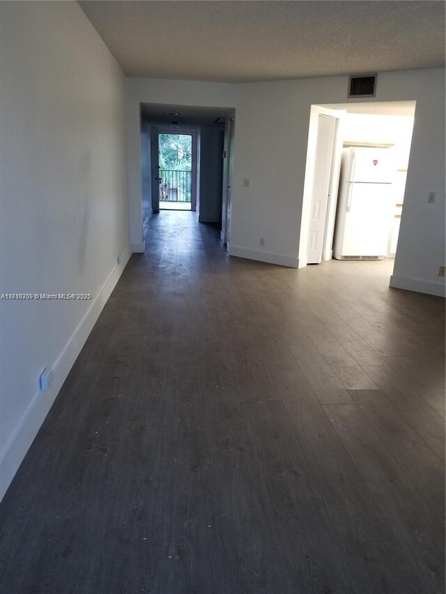 empty room featuring dark wood-type flooring