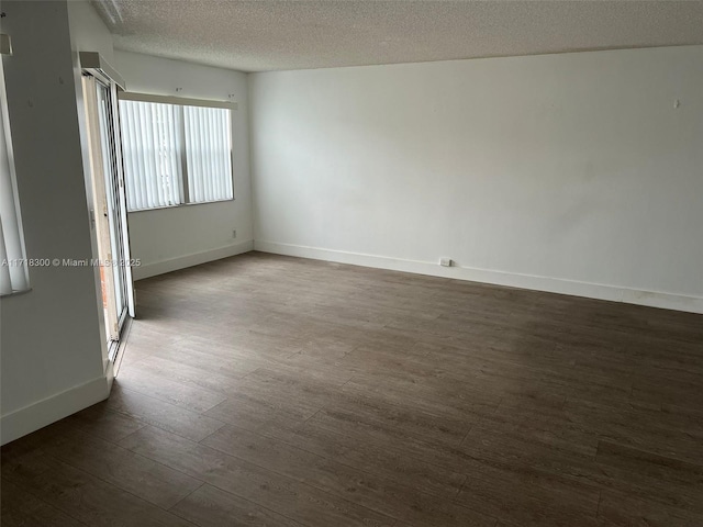 unfurnished room featuring a textured ceiling and dark wood-type flooring