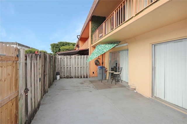 view of patio featuring a balcony