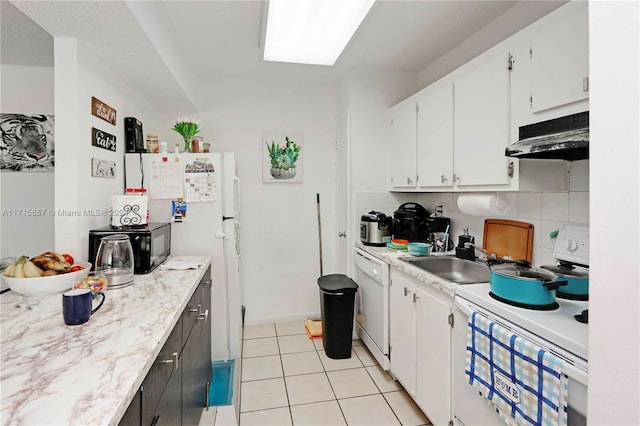 kitchen featuring white cabinets, white appliances, sink, and light tile patterned floors