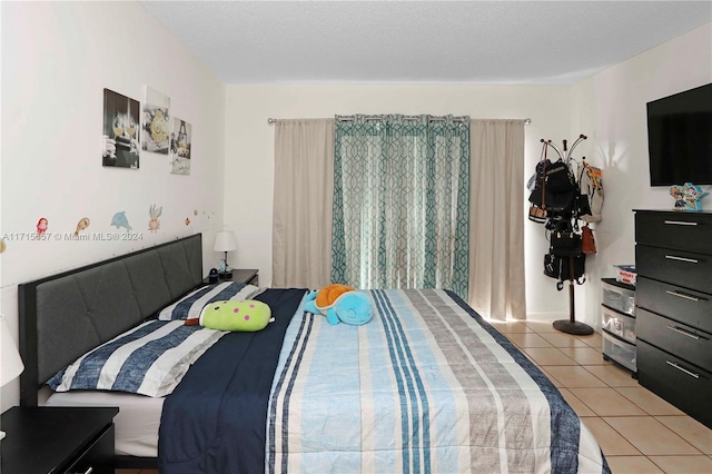 tiled bedroom with a textured ceiling