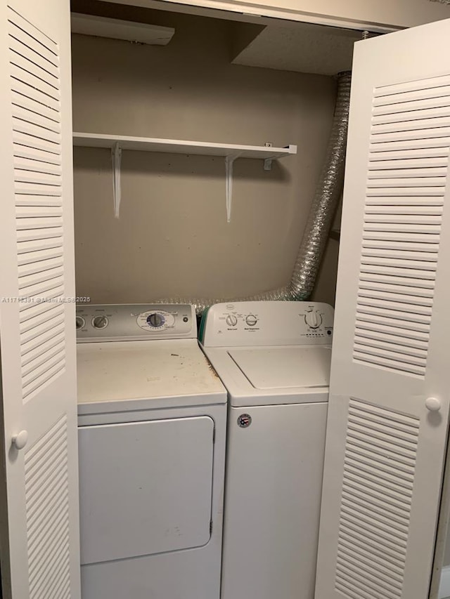 washroom with washing machine and dryer