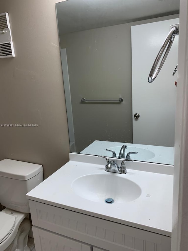 bathroom featuring vanity and toilet